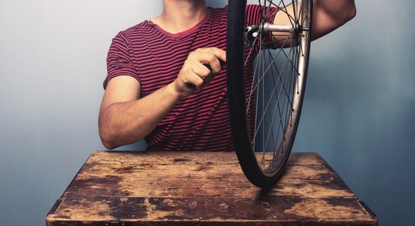 Man fixing bicycle tyre